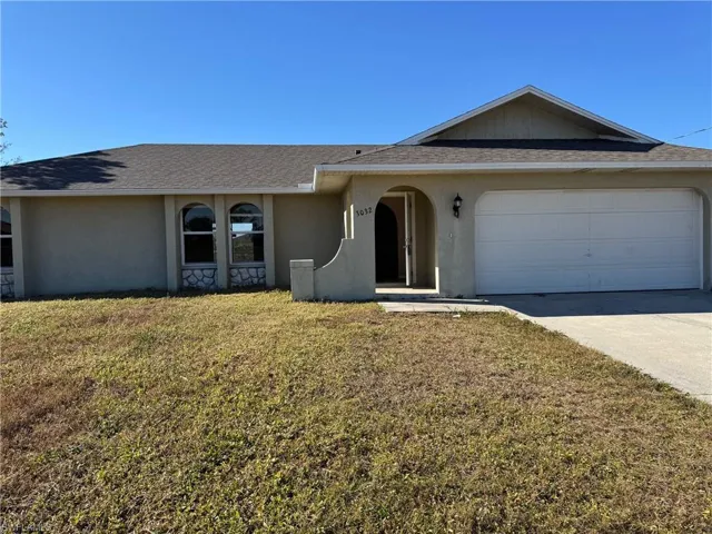 View of side of home with a yard