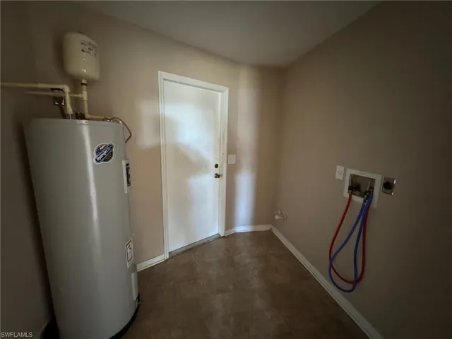 Kitchen with sink, white cabinets, black appliances, and vaulted ceiling