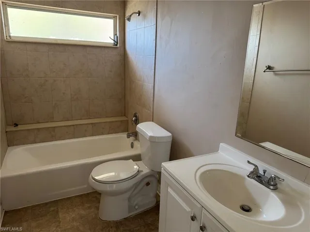 Unfurnished room with ceiling fan and concrete flooring