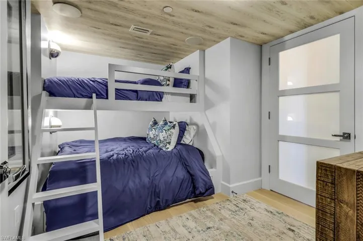 Bedroom with light wood-type flooring and wood ceiling
