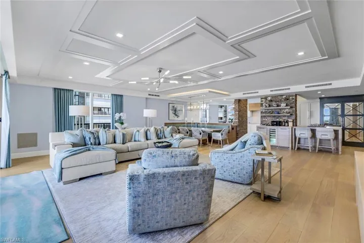 Living room with light hardwood / wood-style flooring and coffered ceiling