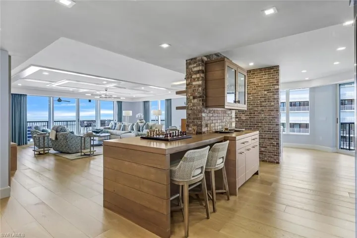 Kitchen with white cabinets and light hardwood / wood-style flooring