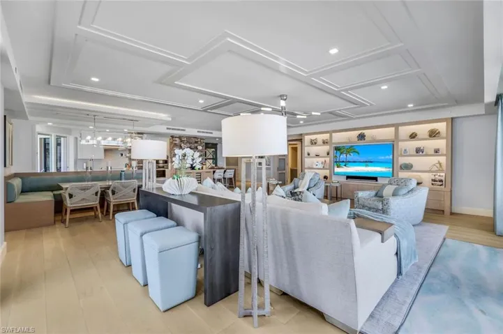 Living room with ceiling fan and light hardwood / wood-style floors