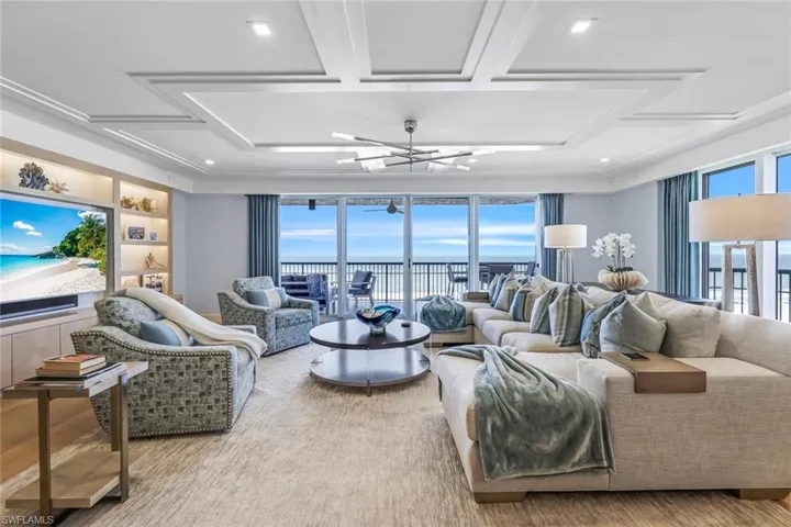 Living room with hardwood / wood-style flooring and an inviting chandelier