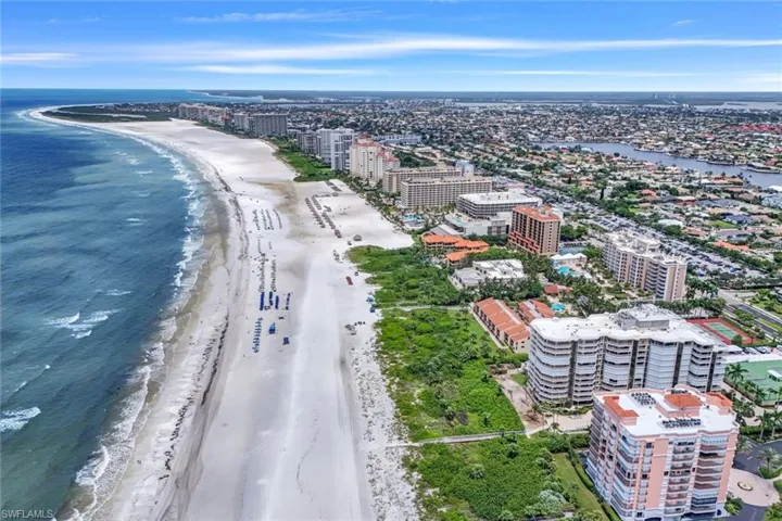 Drone / aerial view featuring a beach view and a water view