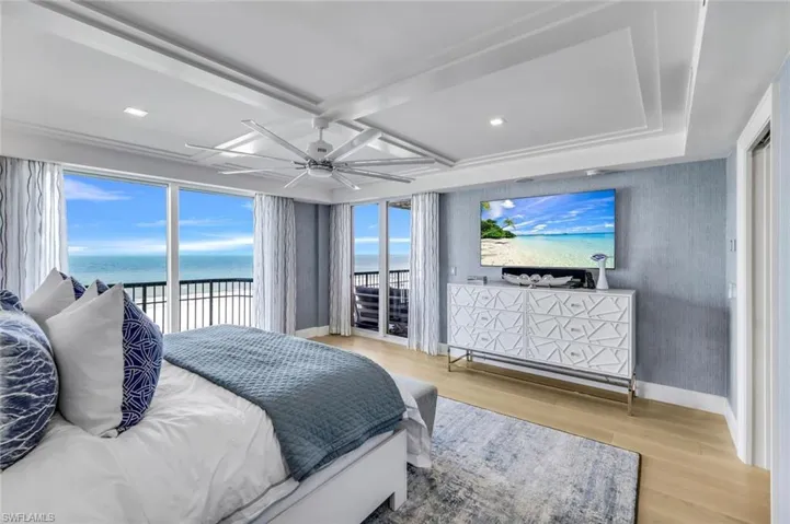 Bedroom with access to exterior, light hardwood / wood-style flooring, and ceiling fan