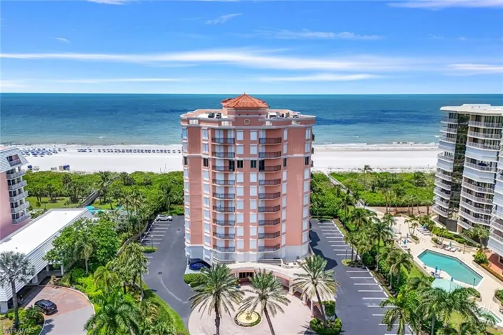 Bird's eye view featuring a water view and a beach view