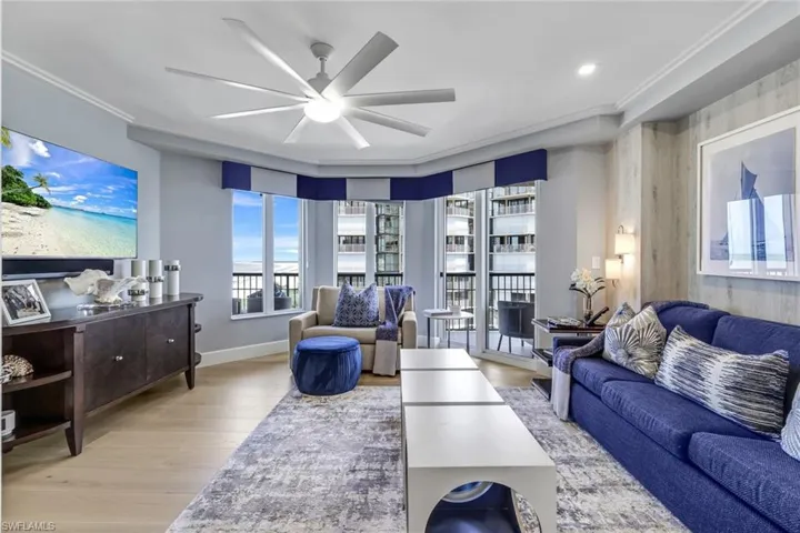 Living room featuring ceiling fan, light hardwood / wood-style flooring, and ornamental molding