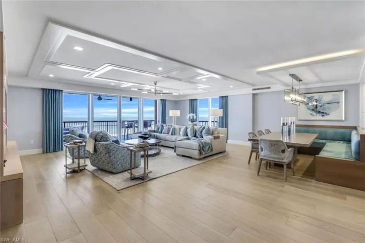 Living room featuring a wall of windows, light hardwood / wood-style flooring, and a wealth of natural light