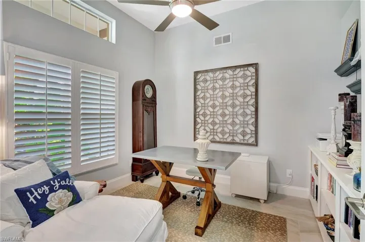 Living area with a high ceiling and ceiling fan
