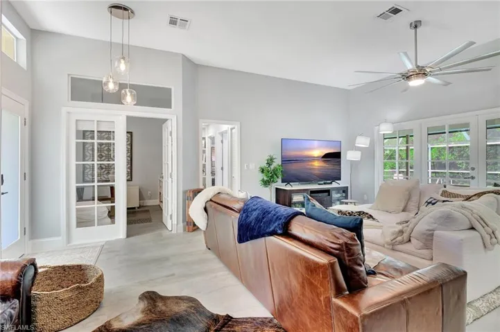 Living room with ceiling fan and french doors