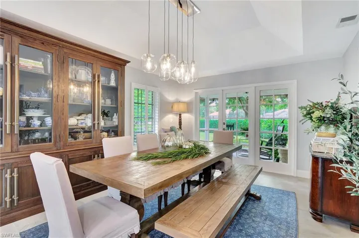 Dining area featuring a raised ceiling and a notable chandelier