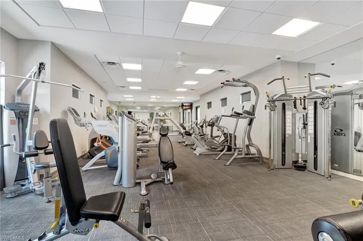 Exercise room featuring carpet flooring and a drop ceiling