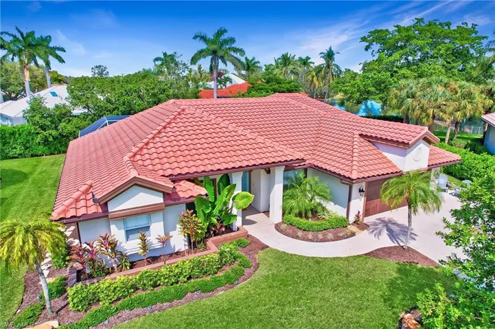View of front of house featuring a garage and a front yard