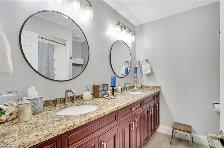 Bathroom with tile patterned floors, toilet, and vanity