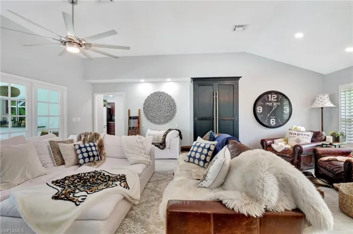 Living room featuring lofted ceiling and ceiling fan
