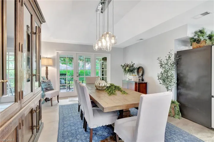 Dining area featuring light tile patterned floors and an inviting chandelier