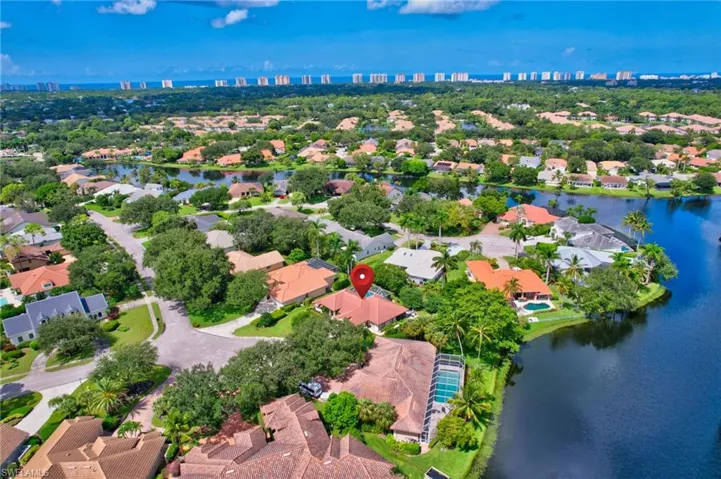 Birds eye view of property with a water view