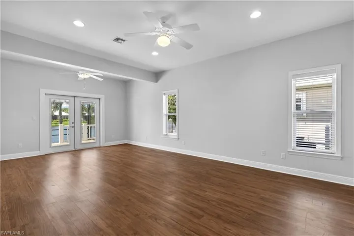 Huge primary bedroom with access to the pool from french doors