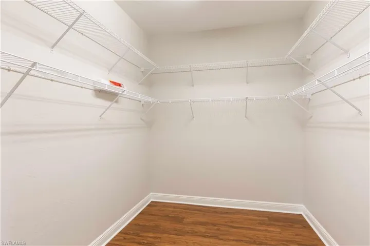 Walk in closet with wood finished floors- Primary bedroom- Huge!!!