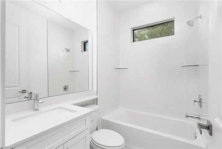 Bathroom featuring vanity and washtub / shower combination