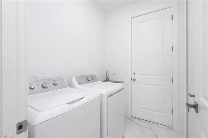 Laundry room featuring separate washer and dryer