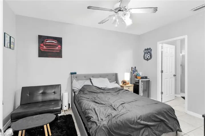 Bedroom with a ceiling fan and light tile patterned floors