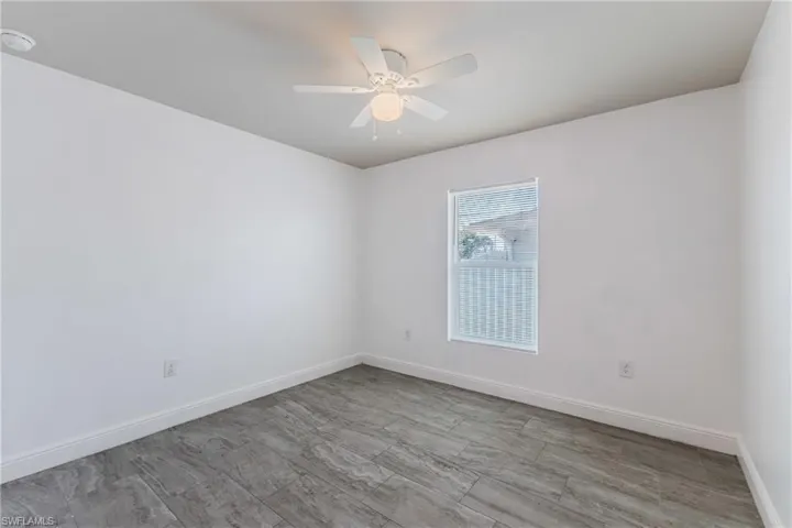 Unfurnished room featuring ceiling fan and wood finish floors
