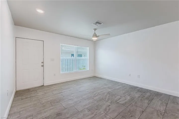 Spare room with baseboards and a ceiling fan