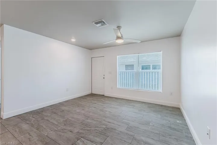 Empty room featuring a ceiling fan and recessed lighting