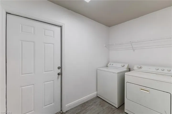 Laundry room with light wood-style floors and independent washer and dryer