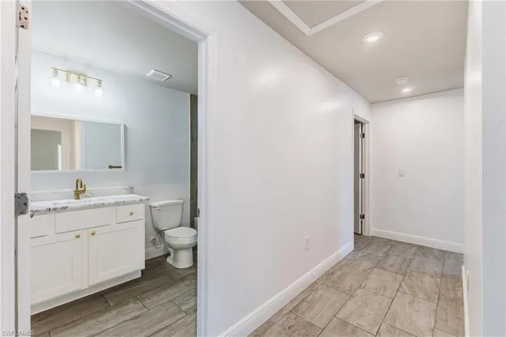 Bathroom with vanity, recessed lighting, and wood tiled floors