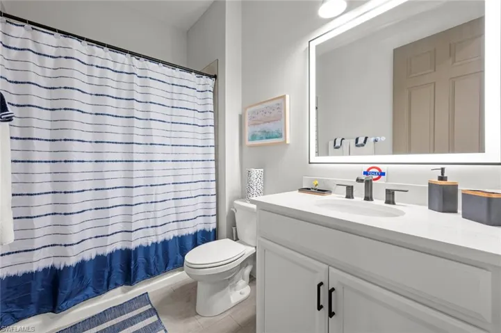 Full bathroom with vanity and toilet