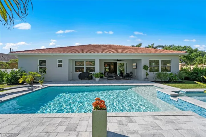 View of swimming pool with a patio area, an in-ground hot tub, and an outdoor living space