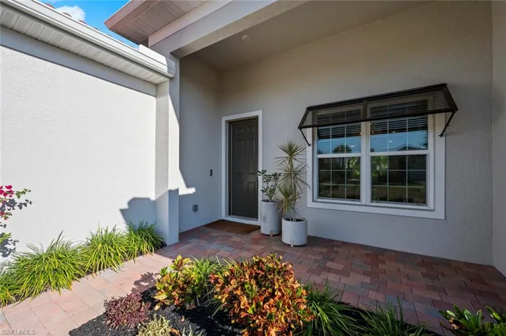 Entrance to property featuring stucco siding