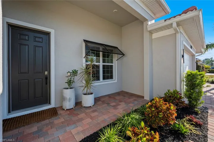 Entrance to property featuring stucco siding