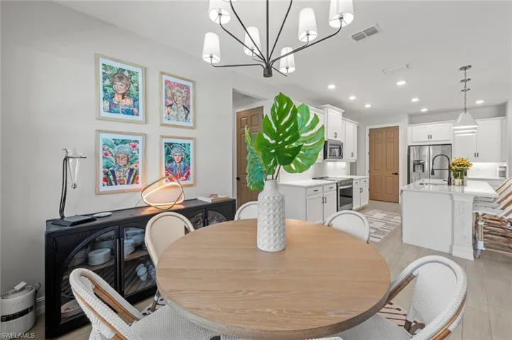 Dining space with recessed lighting, light wood finished floors, and a chandelier