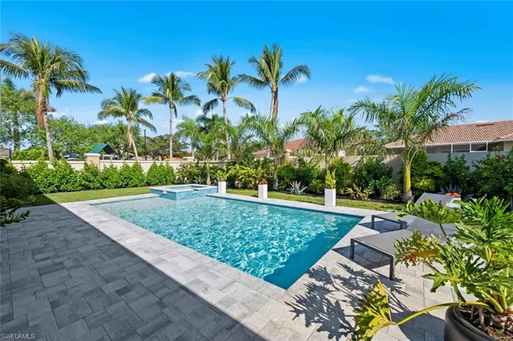 View of pool featuring a patio area and a pool with connected hot tub