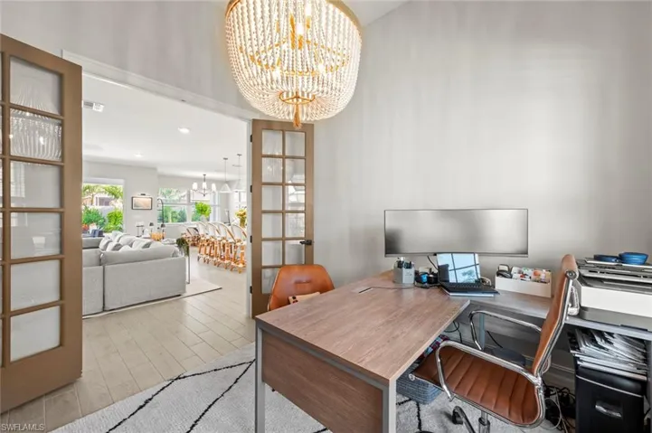 Home office featuring a chandelier, wood tiled floors, french doors, and recessed lighting