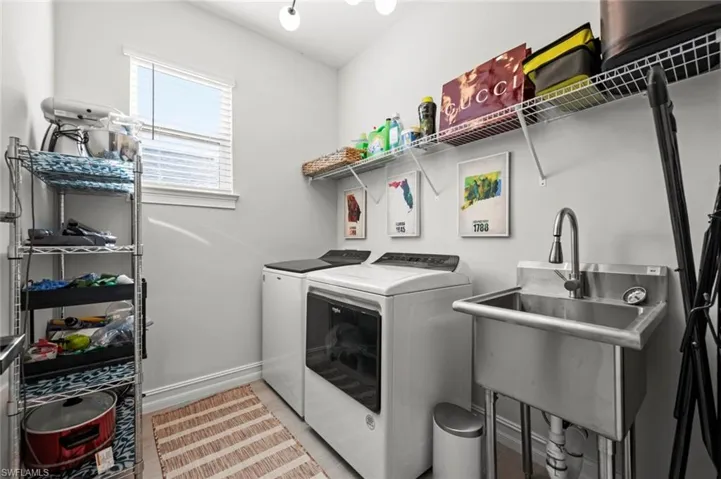 Laundry room featuring baseboards and separate washer and dryer