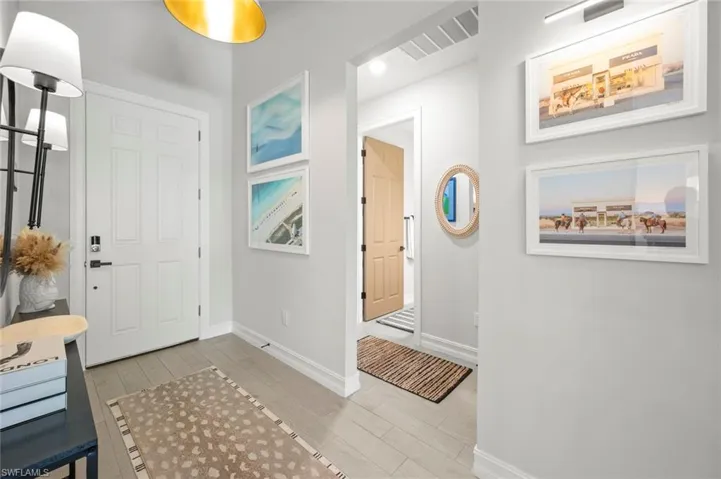 Foyer with light wood-style flooring and recessed lighting