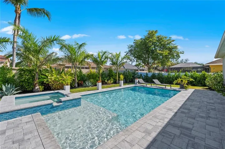 View of pool featuring a patio and a pool with connected hot tub