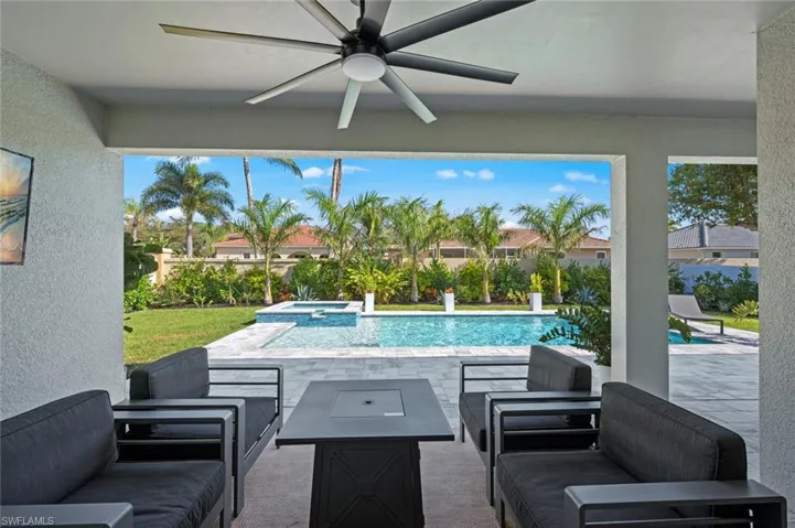 View of pool featuring a patio area, an outdoor hangout area, and a pool with connected hot tub