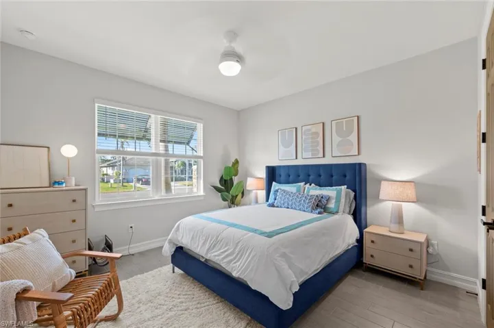 Bedroom with wood finished floors and ceiling fan