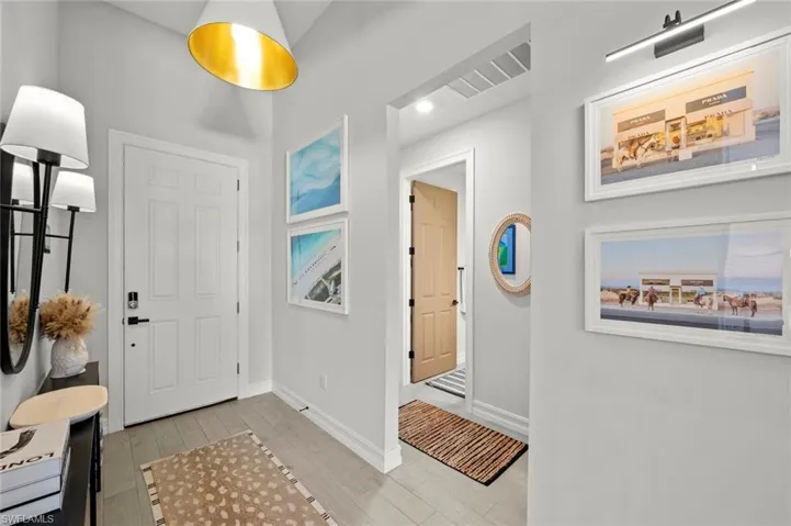 Foyer entrance with wood tiled floors and recessed lighting