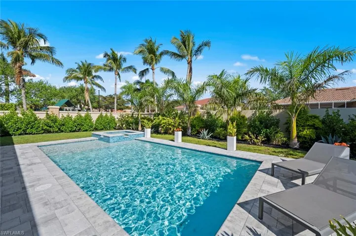 View of pool featuring a patio and a pool with connected hot tub