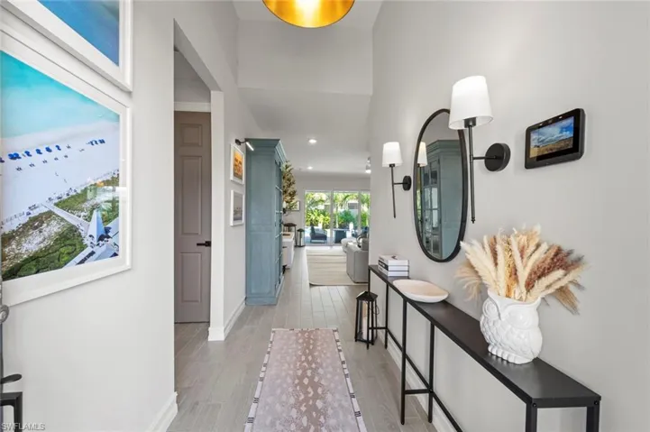 Hallway with wood finish floors and recessed lighting