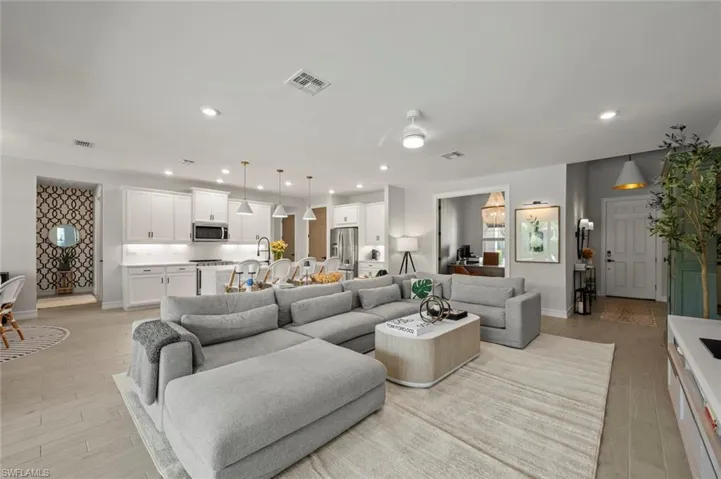Living area with recessed lighting and light wood finished floors