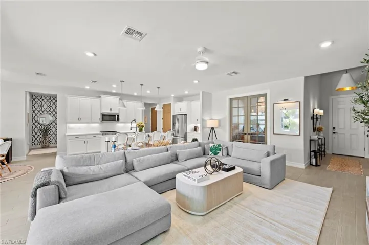 Living room with recessed lighting and light wood finished floors