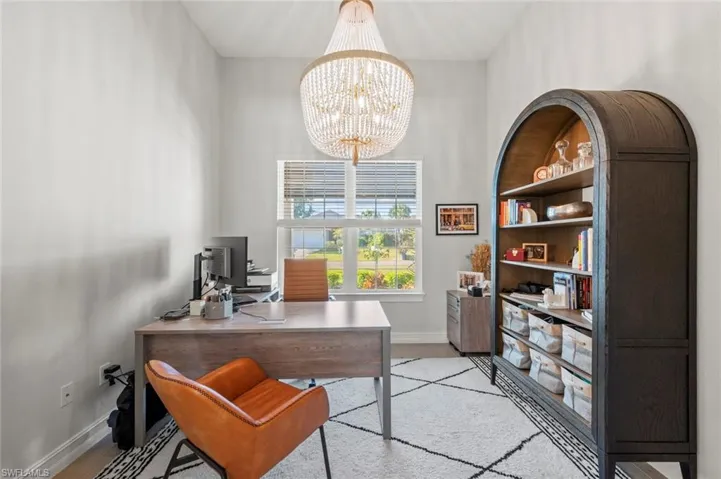 Office with a chandelier and a high ceiling
